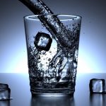Water Pouring Into Glass with Ice